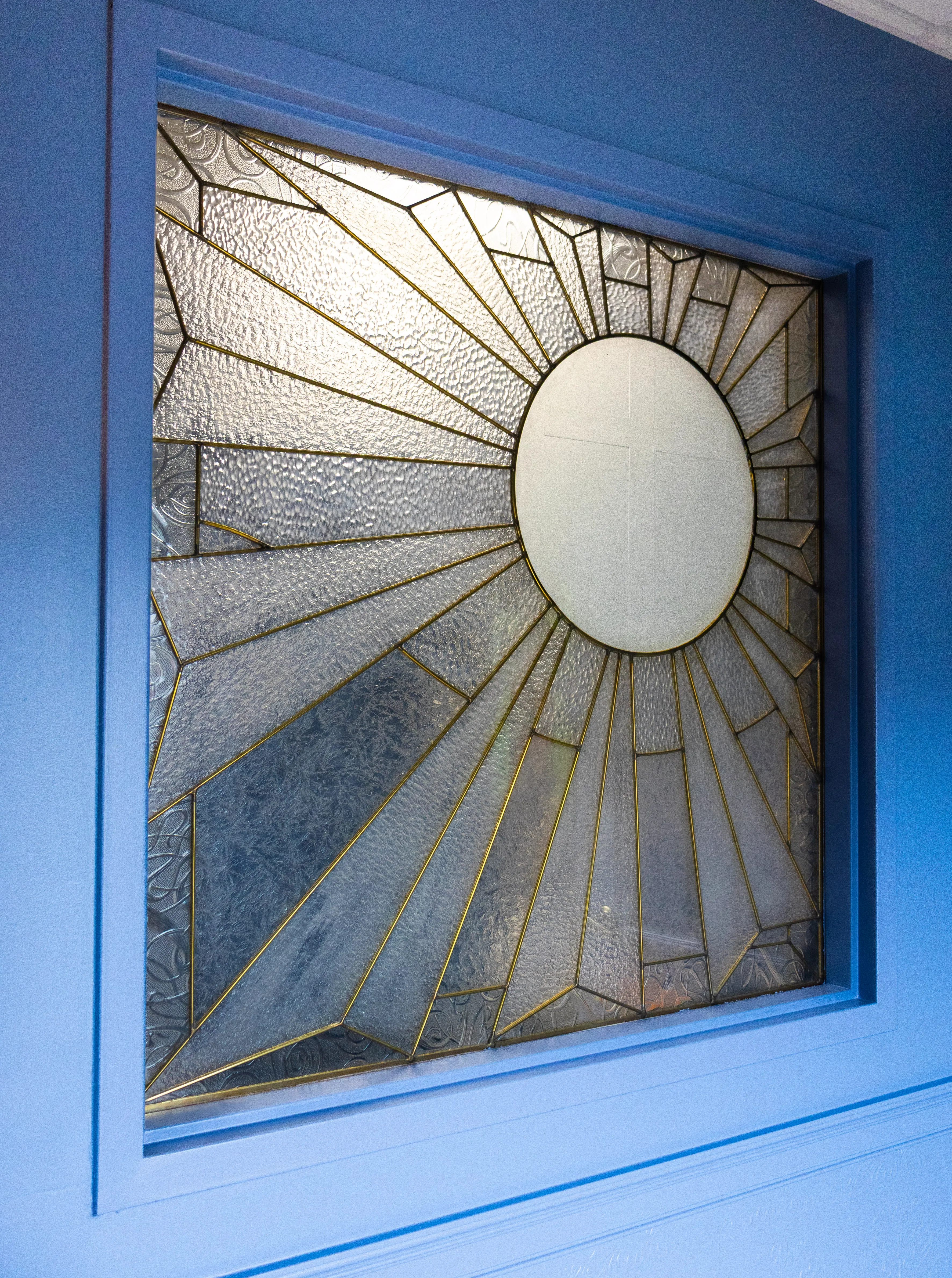 A stained glass window with sunburst details
